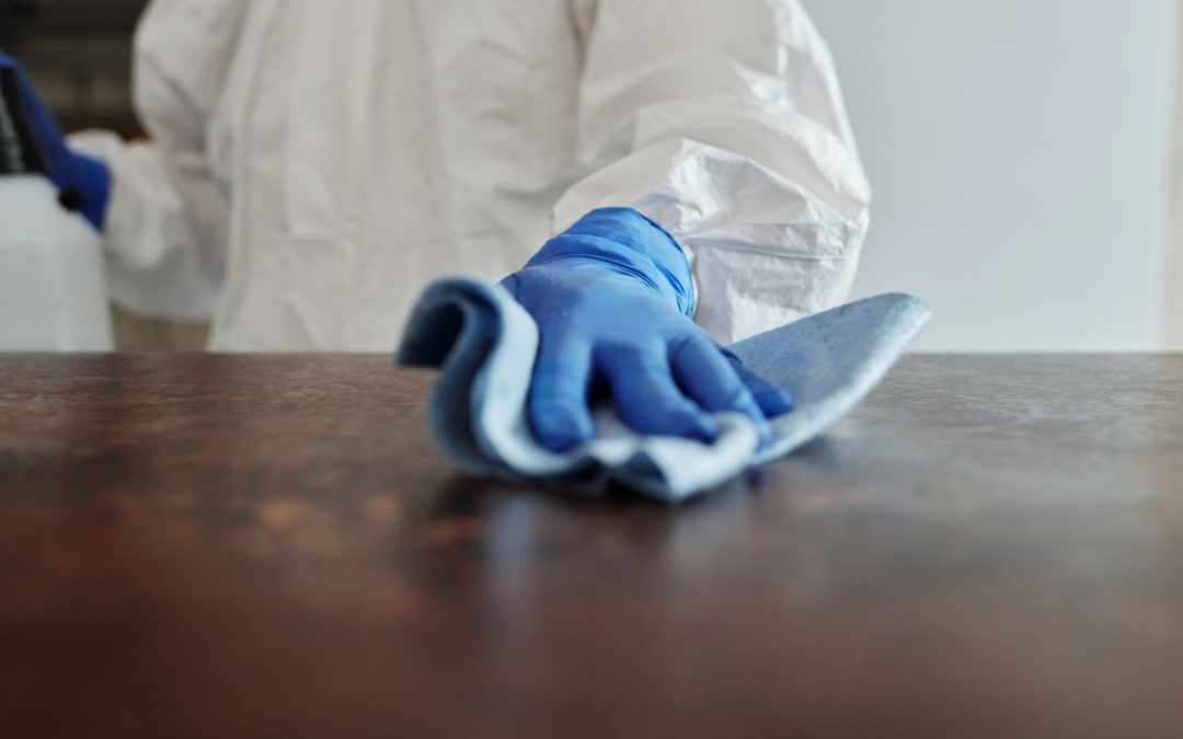 Cleaner wiping tabletop with cloth