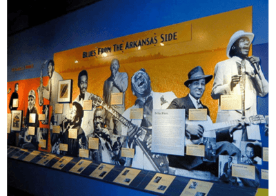 A blue wall with a large wide yellow graphic on top of it, with various duotone musical figures.