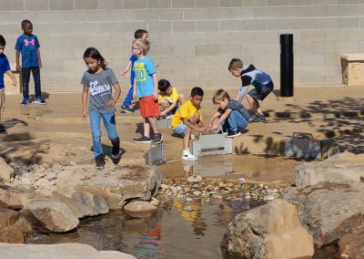 Young visitors learning about ranching at an outdoor exhibit at the National Ranching Heritage Center