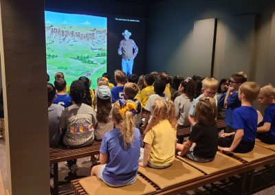 Young visitors watching a film at the National Ranching Heritage Center