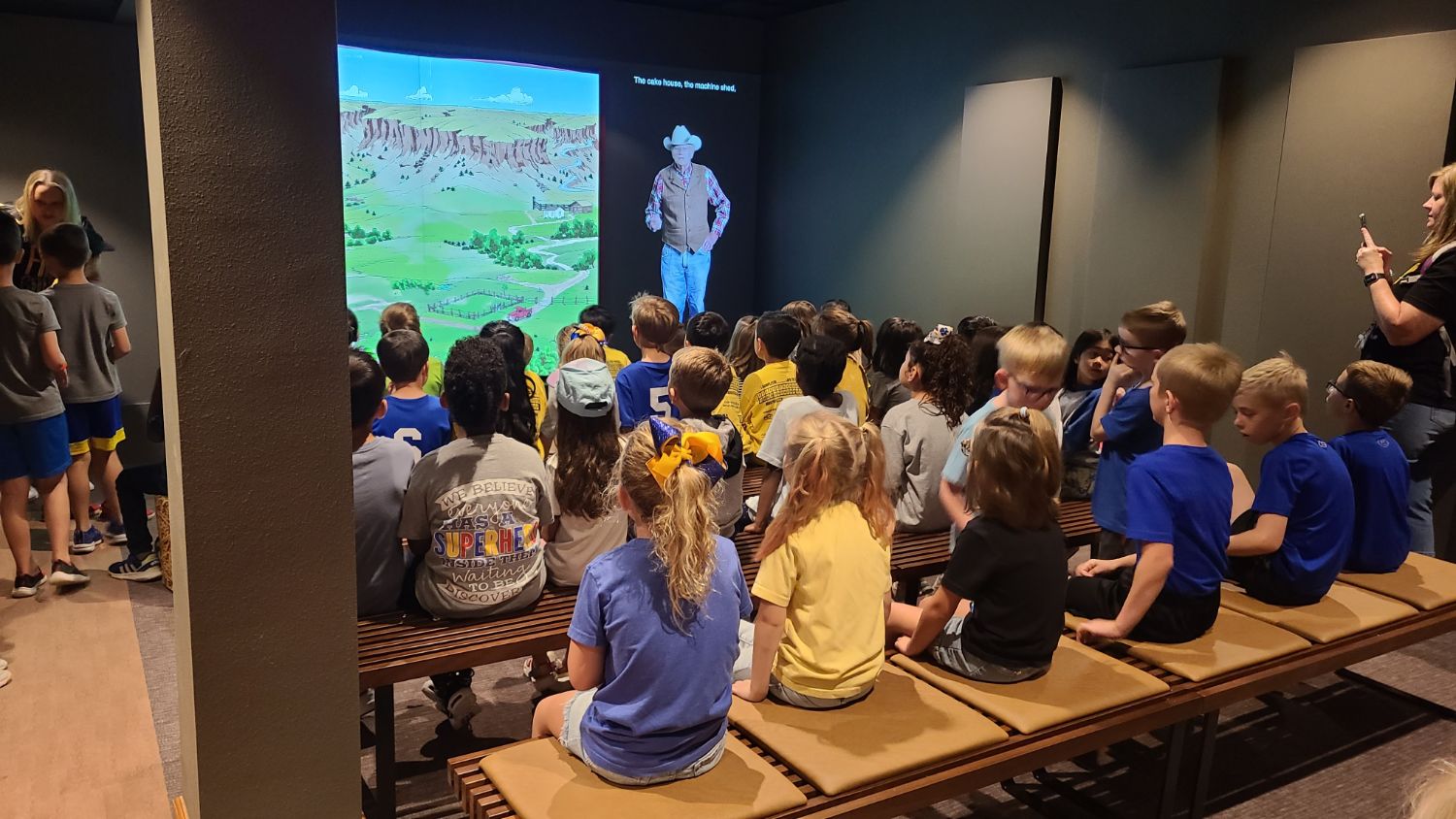 Young visitors watching a film at the National Ranching Heritage Center