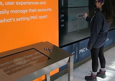 A metallic touch table in a bank lobby.