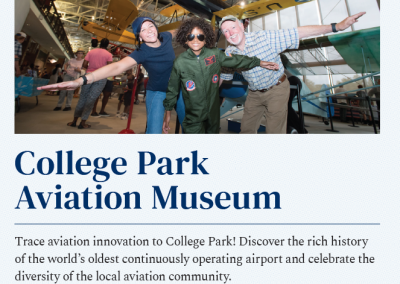 Three people spread their arms out as if flying while in an airplane museum.